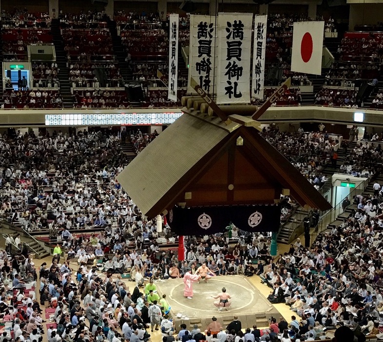 Grand sumo tournament scene inside Ryogoku Kokugikan in Tokyo