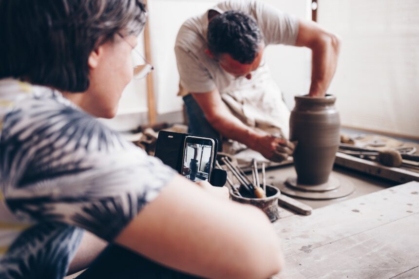 Hands shaping clay on a pottery wheel during a workshop