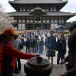 Visitors lighting incense at a Buddhist temple in Nara