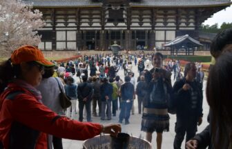 Visitors lighting incense at a Buddhist temple in Nara