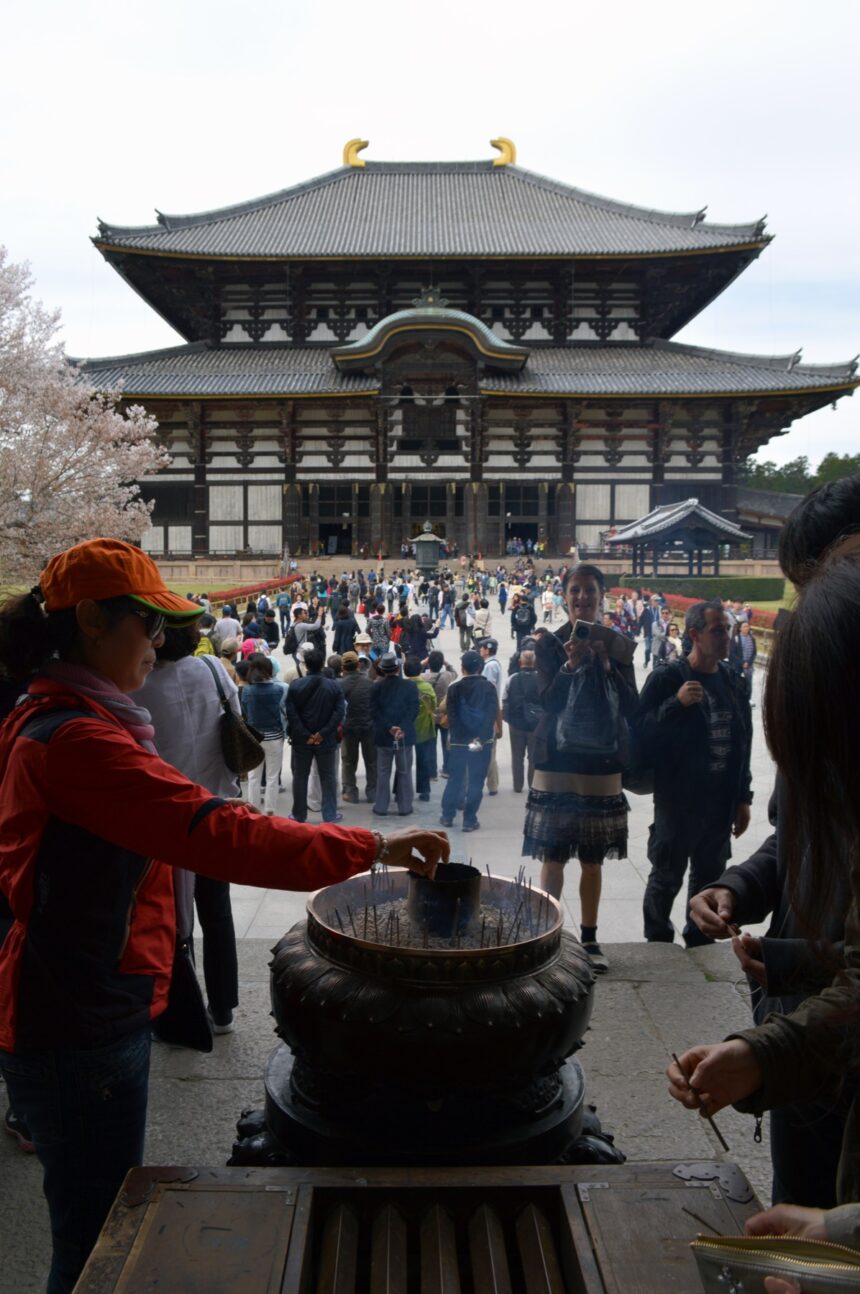 Visitors lighting incense at a Buddhist temple in Nara