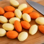 にんじんとじゃがいもをシャトーむきで面のある丸い形に整えたイメージ