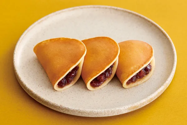 皿に並べた銘菓「つばらつばら」3個。断面に小倉あんが見える